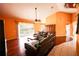 Open concept living room with hardwood floors, cathedral ceiling, and natural light at 7345 Brightwaters Ct, New Port Richey, FL 34652