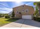 Rear of home showing an attached garage, fenced yard, and screened in patio at 7345 Brightwaters Ct, New Port Richey, FL 34652
