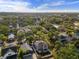 A sprawling aerial view shows homes in a community with lush trees at 7417 S Morton St, Tampa, FL 33616