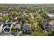 An aerial view features neighborhood houses nestled among lush trees at 7417 S Morton St, Tampa, FL 33616