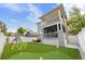 Wide angle shot of the backyard featuring putting green, playground, patio, and multi-story house at 7417 S Morton St, Tampa, FL 33616