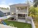 Aerial view of the home's backyard features artificial turf, patio, playset, and putting green at 7417 S Morton St, Tampa, FL 33616