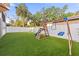 Spacious backyard with artificial turf, a playset and white fencing create the perfect Gathering oasis at 7417 S Morton St, Tampa, FL 33616