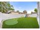 Spacious backyard with artificial turf, putting green, playset and fenced yard for privacy and Gathering fun at 7417 S Morton St, Tampa, FL 33616