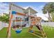 A perfect backyard including a playset, seating area, climbing dome and a lush artificial lawn at 7417 S Morton St, Tampa, FL 33616