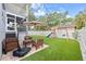 This backyard features a playset, wooden seating area, and lush artificial turf at 7417 S Morton St, Tampa, FL 33616