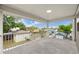 A covered balcony providing an outdoor living space with a view of the surrounding neighborhood at 7417 S Morton St, Tampa, FL 33616