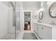 Stylish bathroom with dual sinks, marble countertops, and a glass enclosed shower with rainfall showerhead at 7417 S Morton St, Tampa, FL 33616