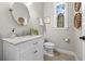 Powder room features a decorative mirror, marble countertop, and a window at 7417 S Morton St, Tampa, FL 33616