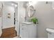 Well-lit bathroom with a marble vanity, oval mirror, and tiled floors at 7417 S Morton St, Tampa, FL 33616