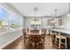 Dining room with a hardwood floor, chandelier lighting, and large window at 7417 S Morton St, Tampa, FL 33616