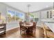 Dining room featuring a chandelier, hardwood floor and large windows at 7417 S Morton St, Tampa, FL 33616