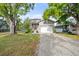 Charming two-story home featuring a welcoming red front door, gray brick driveway and attached two-car garage at 7417 S Morton St, Tampa, FL 33616