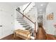 Bright foyer with hardwood floors, bench seating, and staircase at 7417 S Morton St, Tampa, FL 33616