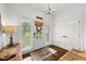 Bright foyer featuring a chandelier, hardwood floors, and views of the outdoors at 7417 S Morton St, Tampa, FL 33616