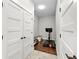 Hallway with gym equipment, storage, and hardwood floors at 7417 S Morton St, Tampa, FL 33616