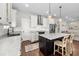 Open-concept kitchen with stainless steel appliances, marble countertops, kitchen island and subway tile backsplash at 7417 S Morton St, Tampa, FL 33616