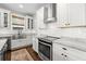Beautiful kitchen with stainless steel appliances, marble countertops, white cabinetry, and an undermount sink at 7417 S Morton St, Tampa, FL 33616