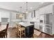Bright kitchen with stainless steel appliances, marble countertops, kitchen island with breakfast bar, and pendant lighting at 7417 S Morton St, Tampa, FL 33616