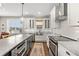 Spacious kitchen with stainless steel appliances, marble countertops and backsplash, and an undermount sink at 7417 S Morton St, Tampa, FL 33616