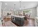 Open-concept kitchen with island, stainless steel appliances, and seamless flow to living and dining areas at 7417 S Morton St, Tampa, FL 33616