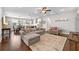 Open-concept living room boasts hardwood floors, comfortable seating, and seamless flow to the kitchen and dining area at 7417 S Morton St, Tampa, FL 33616