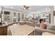 Open living room featuring hardwood floors, comfortable seating, and access to the backyard at 7417 S Morton St, Tampa, FL 33616