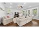 Bright living room features hardwood floors, a ceiling fan, and large windows at 7417 S Morton St, Tampa, FL 33616