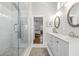 Main bathroom featuring dual sinks with marble countertops and a glass enclosed shower at 7417 S Morton St, Tampa, FL 33616