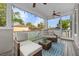 Screened patio with furniture, ceiling fans, and an exterior view of the neighborhood at 7417 S Morton St, Tampa, FL 33616