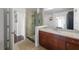Bathroom with glass shower, granite countertop, cherry cabinets and tan flooring at 777 N Ashley Dr # 2610, Tampa, FL 33602