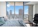 Bedroom features a skyline view with floor-to-ceiling windows, hardwood floors, and a comfortable workspace, day view at 777 N Ashley Dr # 2610, Tampa, FL 33602
