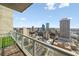 Balcony view with artificial turf, glass railings, and cityscape views on a sunny day at 777 N Ashley Dr # 2610, Tampa, FL 33602