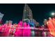 Night view of a modern high-rise building with vibrant pink fountains in front of it at 777 N Ashley Dr # 2610, Tampa, FL 33602