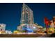 Exterior night view of a modern high-rise with palm trees and architectural lighting at 777 N Ashley Dr # 2610, Tampa, FL 33602