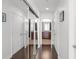 Hallway with wood floors leading to bathrooms with mirrored closet doors and white trim at 777 N Ashley Dr # 2610, Tampa, FL 33602