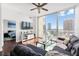 Bright living room with a ceiling fan, city views, and access to the balcony at 777 N Ashley Dr # 2610, Tampa, FL 33602