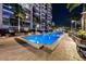 Beautifully lit swimming pool at night, surrounded by palm trees and modern architecture at 777 N Ashley Dr # 2610, Tampa, FL 33602