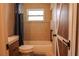 Neutral bathroom features a shower-tub combo and a stylish barn door at 7827 Crosier Ct, New Port Richey, FL 34653