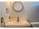 Contemporary bathroom vanity with a modern sink, round mirror, and stylish fixtures at 7827 Crosier Ct, New Port Richey, FL 34653