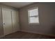 Bedroom showing a closet with white sliding doors and a window that allows natural light at 7827 Crosier Ct, New Port Richey, FL 34653