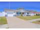 Charming single-story home featuring a well-maintained lawn, a white picket fence, and an attached garage at 7827 Crosier Ct, New Port Richey, FL 34653