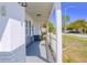 Inviting covered front porch with white pillars offers a charming entry at 7827 Crosier Ct, New Port Richey, FL 34653