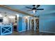 Open-concept kitchen with sleek countertops, stainless steel appliances, a center island, and hardwood floors at 7827 Crosier Ct, New Port Richey, FL 34653