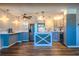 Modern kitchen featuring two-tone cabinets, a stylish island, stainless steel appliances, and updated fixtures at 7827 Crosier Ct, New Port Richey, FL 34653