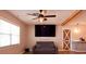 Modern living room with ceiling fan, wood-look flooring, and barn door at 7827 Crosier Ct, New Port Richey, FL 34653