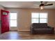 Bright living room featuring a red entry door and a comfortable sofa at 7827 Crosier Ct, New Port Richey, FL 34653
