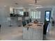 Bright dining room and kitchen with modern white decor and stainless appliances at 7912 Causeway S Blvd, St Petersburg, FL 33707