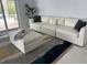 Bright living room with comfortable sofa and plush ottoman at 7912 Causeway S Blvd, St Petersburg, FL 33707