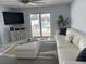 Bright living room with sliding glass doors to the pool and modern white leather couch at 7912 Causeway S Blvd, St Petersburg, FL 33707